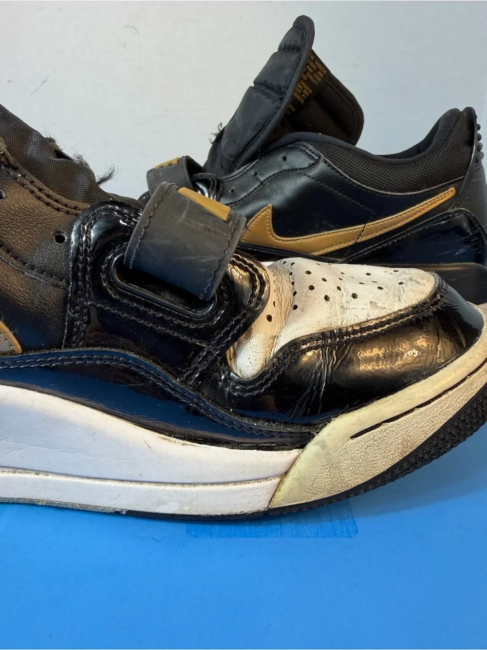 Jordan Black, White & Gold Strap Sneakers